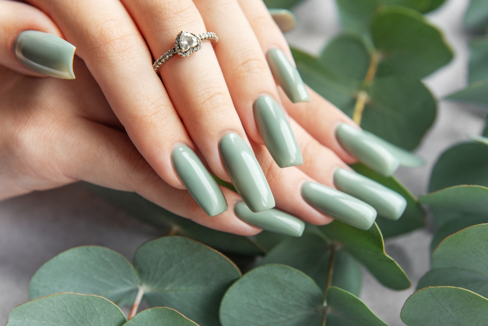 A,Pair,Of,Hands,Adorned,With,Elegant,Green,Nails,Rests